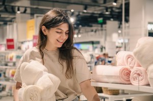 1 A woman happily selecting towels in a store