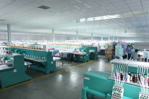 Interior of a bright and spacious textile factory with workers and machinery