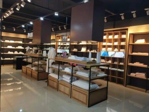 Interior of a well - lit store with neatly arranged textile products