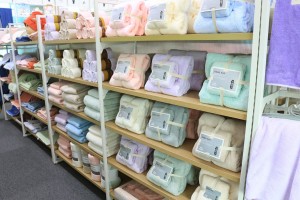 Shelves in a store filled with neatly arranged colorful towels