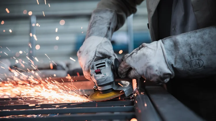 a worker using angle grinder