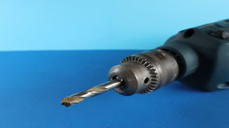 an electric drill in blue backgroud