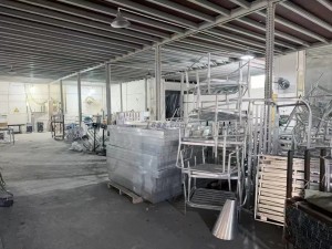 interior of a factory workshop with metal furniture parts and equipment