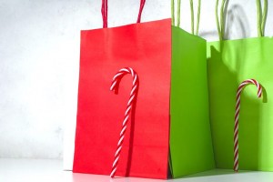 simple-graphic-modern-christmas-mockup-design-with-hard-shadows-candy-cane-sweets-relies-vertical-red-green-background-paper-bags-shopping-christmas-black-friday-sale-concept-copy-space_136595-19625