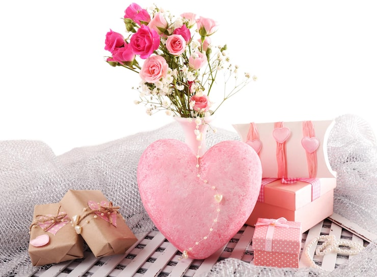 valentine's day arrangement with pink heart vase roses and gift boxes against a white background