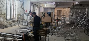 worker in a workshop making metal furniture frames